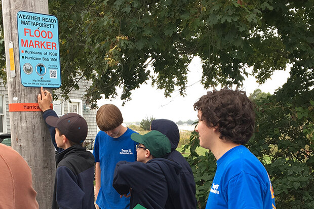 Kids look at a historic high water indicator